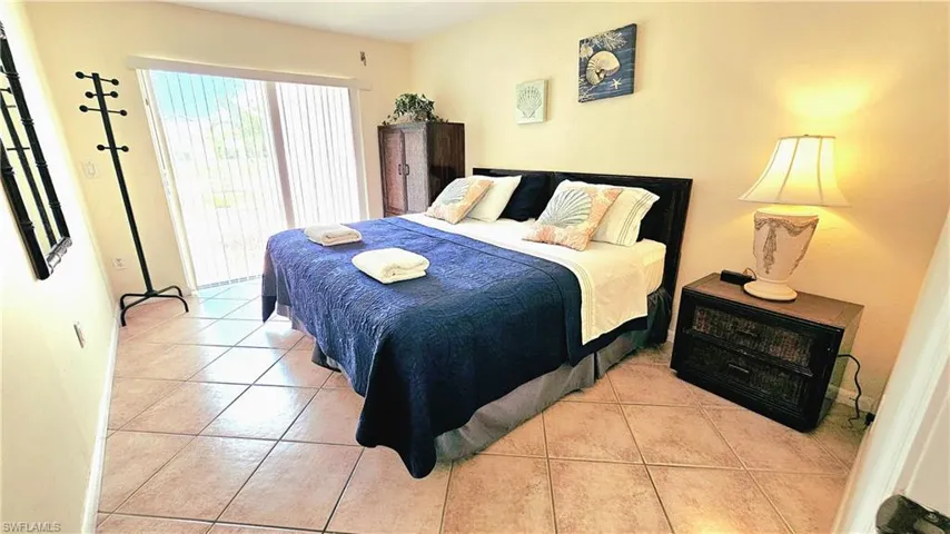 Tiled bedroom featuring access to outside