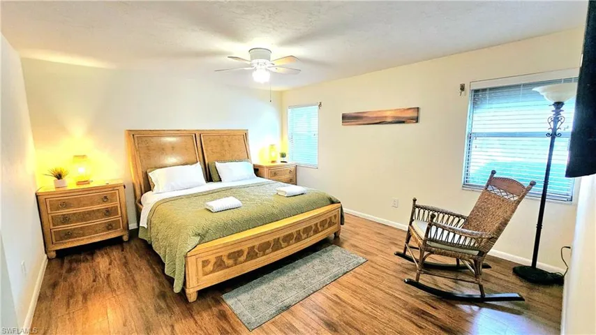 Master Bedroom with multiple windows, ceiling fan, dark hardwood / wood-style floors, and a textured ceiling