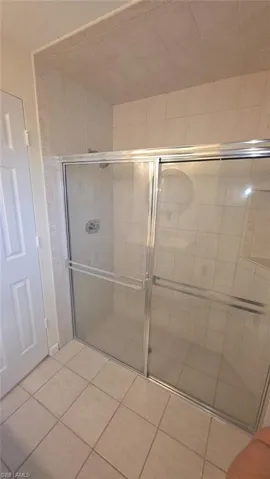 Bathroom with tile patterned flooring and walk in shower