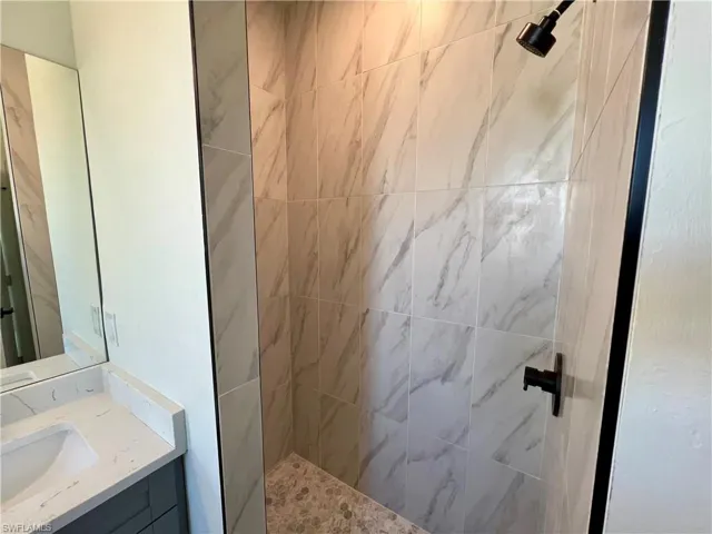 Primary bathroom with tiled walk in shower.