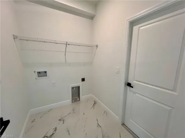 Clothes washing area featuring hookup for a washing machine and electric dryer hookup