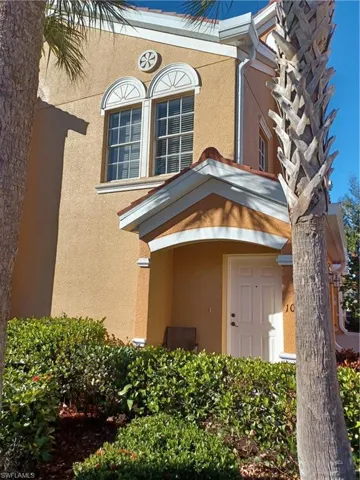 Doorway to property featuring stucco siding
