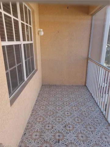 Balcony featuring a sunroom