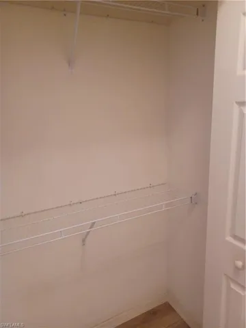 Spacious closet featuring light wood-style flooring