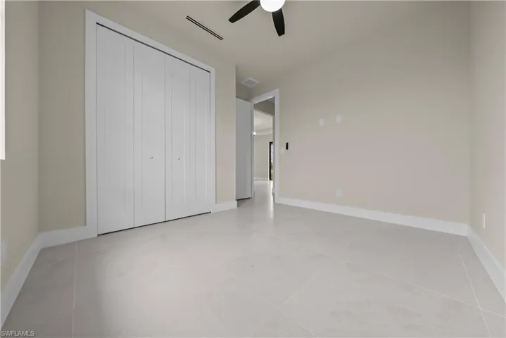 Unfurnished bedroom with a closet and ceiling fan