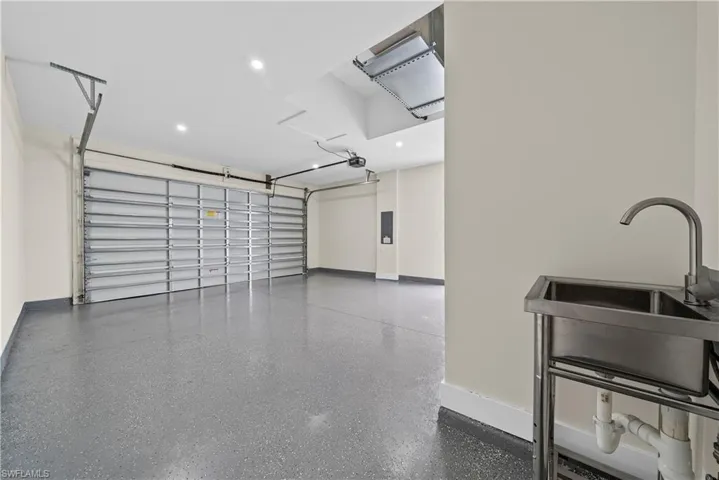 Garage with recessed lighting and electric panel