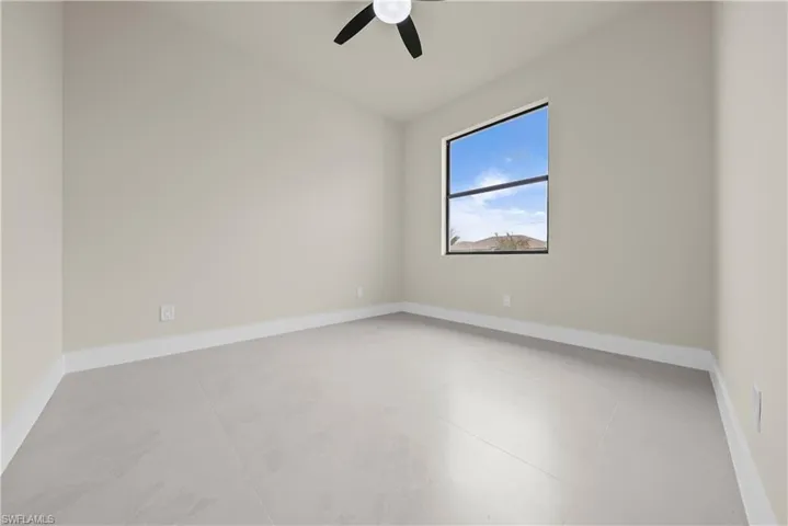 Spare room featuring ceiling fan and concrete floors