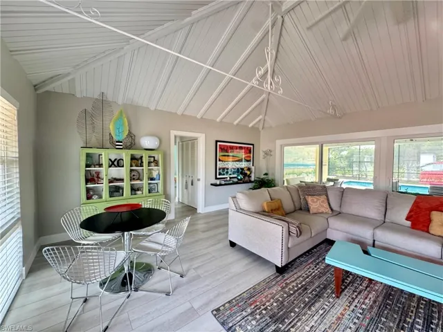 Living room featuring wood finished floors and high vaulted ceiling