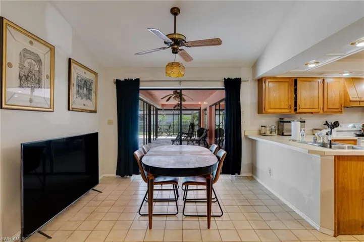 Dining space with a ceiling fan, light tile patterned flooring, and recessed lighting