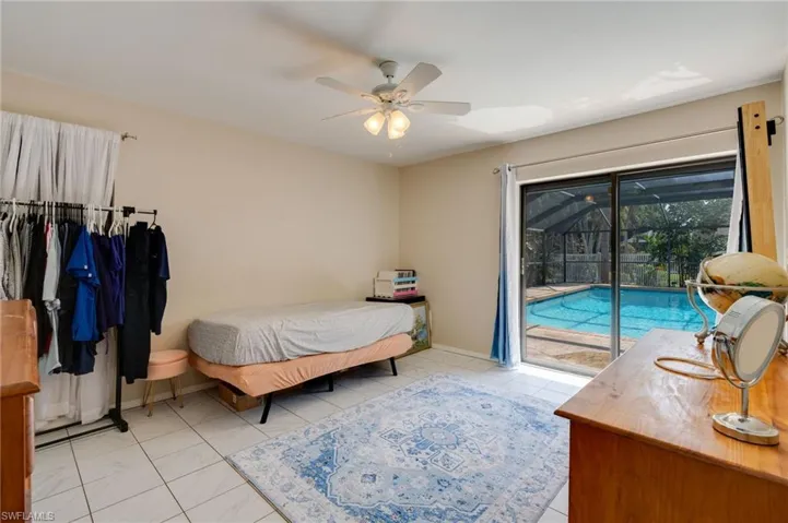 Bedroom featuring ceiling fan, access to outside, and a sunroom