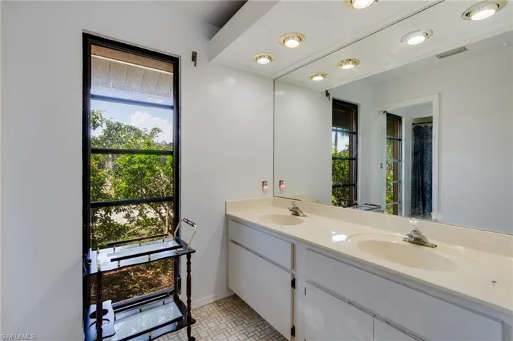 Full bathroom featuring double vanity and a shower with curtain