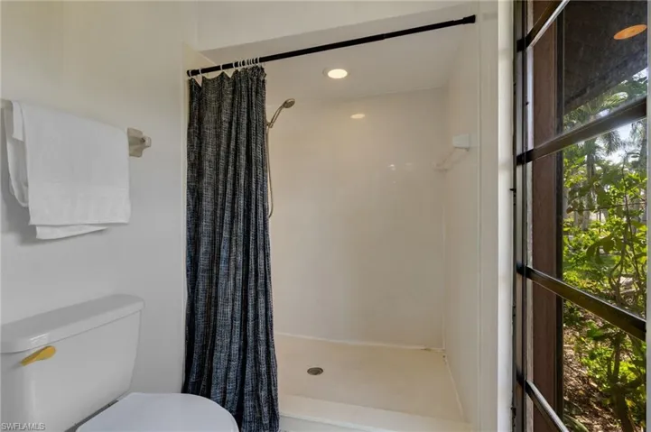 Full bath featuring a shower stall and recessed lighting