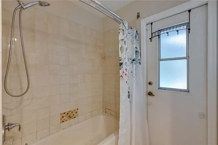 Full bath featuring shower / tub combo with curtain
