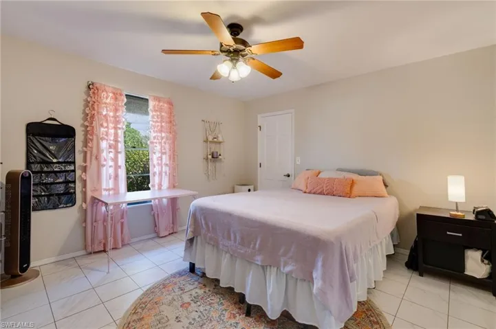 Bedroom featuring ceiling fan and baseboards