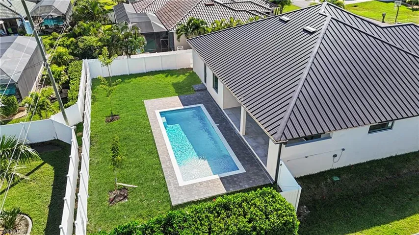View of pool with a fenced backyard, a patio, and a residential view
