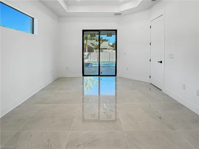 Empty room with a tray ceiling and baseboards