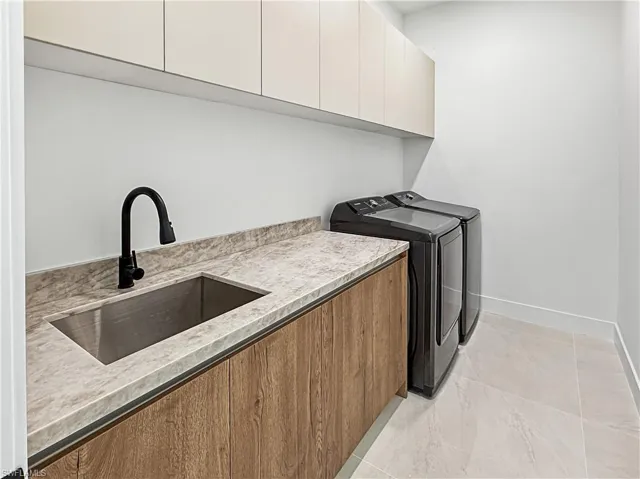 Laundry room with washing machine and clothes dryer and cabinet space