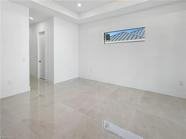 Empty room featuring baseboards and recessed lighting