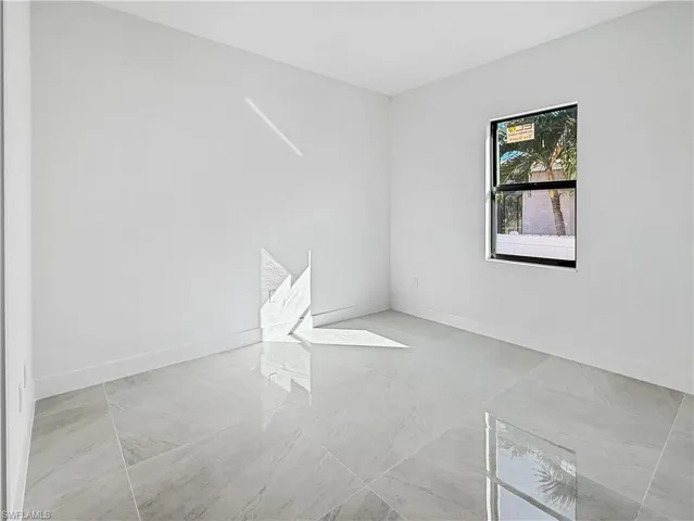 Unfurnished room featuring baseboards