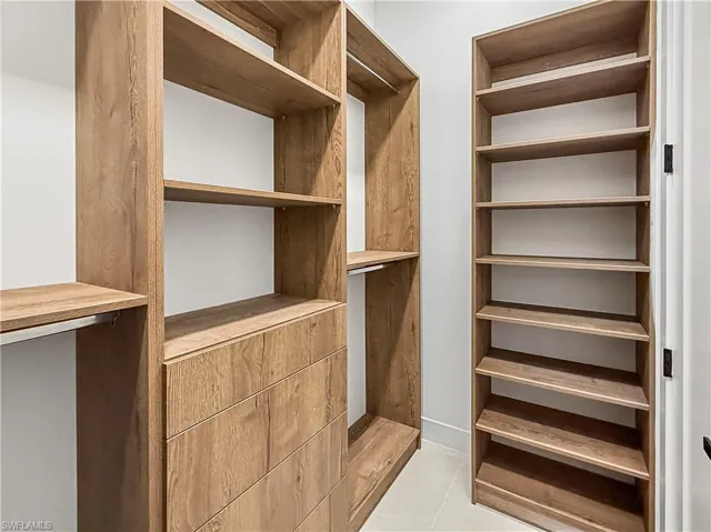 Spacious closet featuring light tile patterned floors