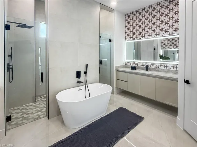 Freestanding soaking tub with matte black fixtures