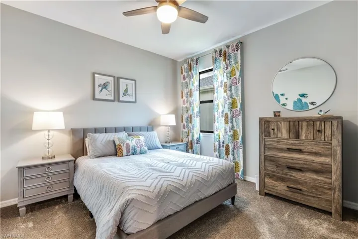 Carpeted bedroom with ceiling fan