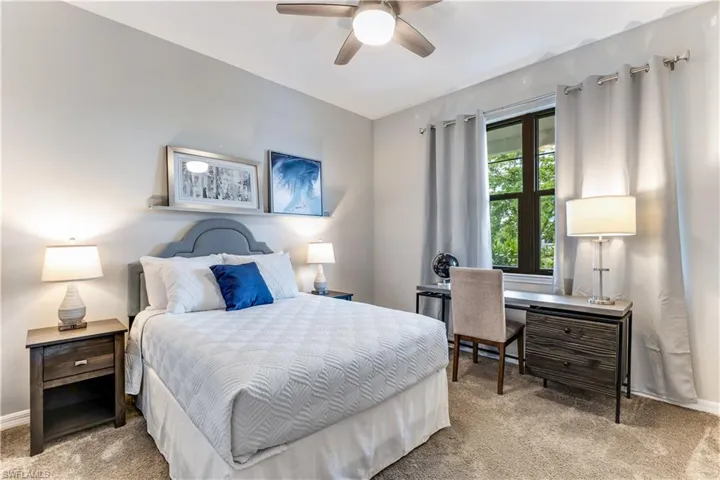 Carpeted bedroom with ceiling fan