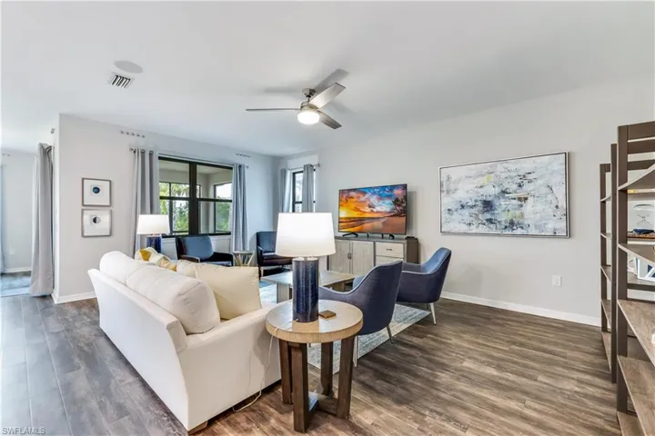 Living room featuring dark hardwood / wood-style flooring and ceiling fan
