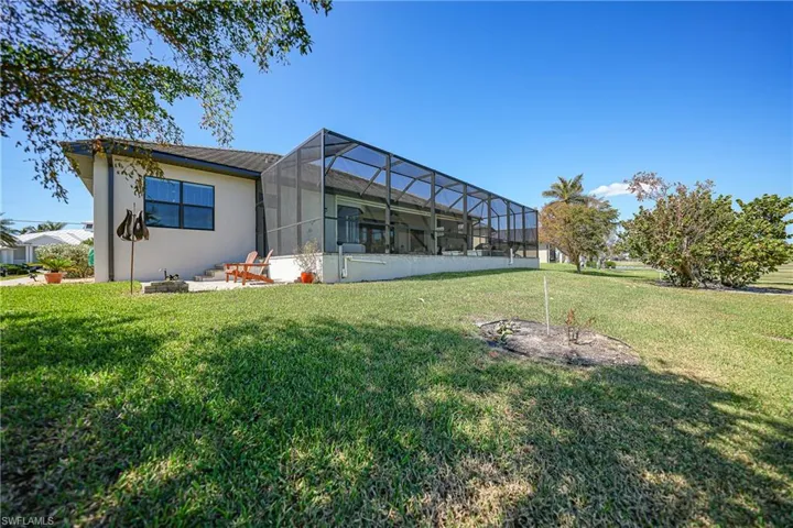 View of yard featuring glass enclosure