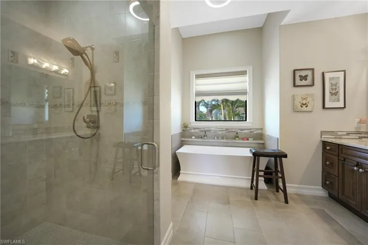 Bathroom with vanity, separate shower and tub, and tile patterned floors