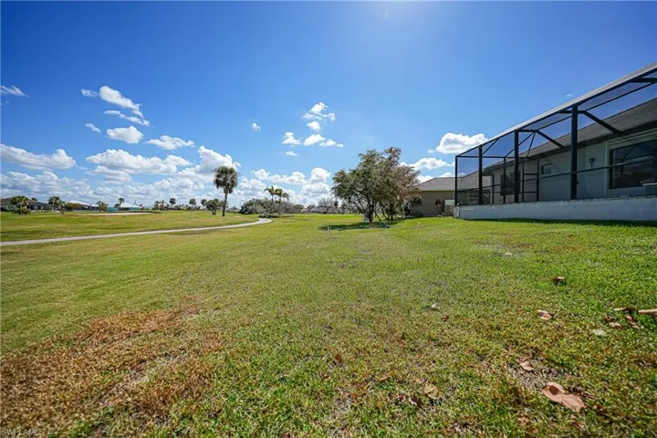 View of yard featuring glass enclosure