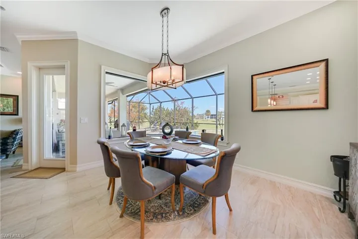 Dining area featuring crown molding and an inviting chandelier