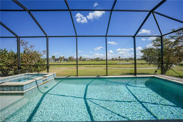 View of pool with a lanai, an in ground hot tub, and a lawn