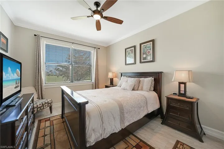 Bedroom featuring ceiling fan, ornamental molding, and light hardwood / wood-style floors