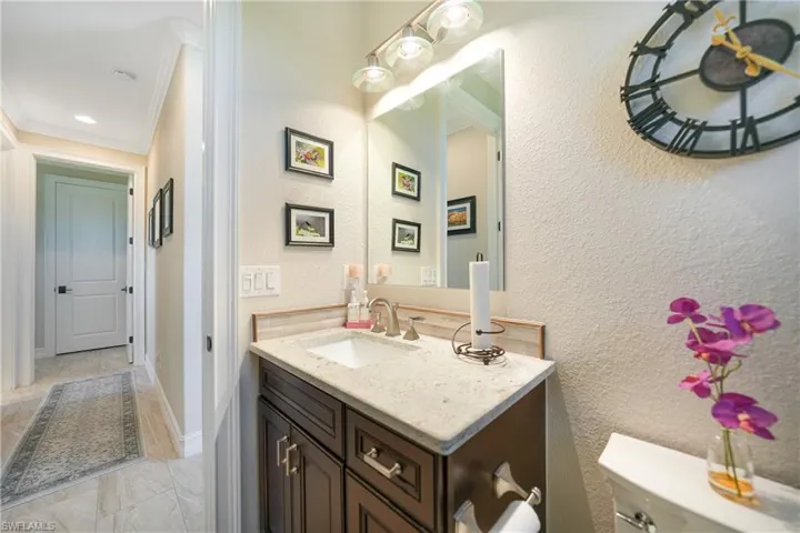 Bathroom with vanity, ornamental molding, and toilet