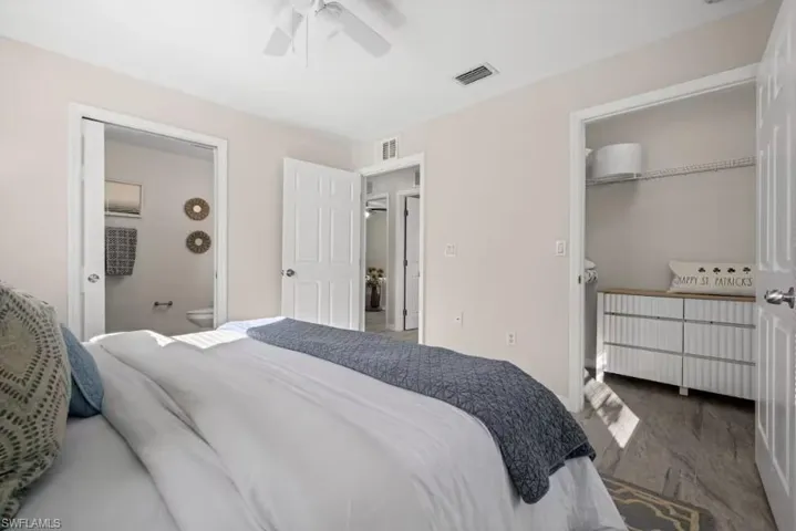 Bedroom with a ceiling fan and connected bathroom