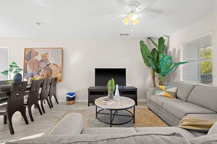 Living room with a ceiling fan and baseboards