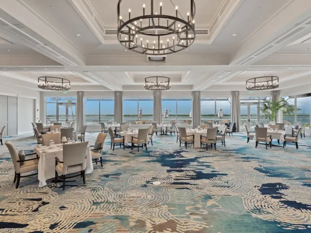Common area with coffered ceiling, crown molding, beam ceiling, and a water view