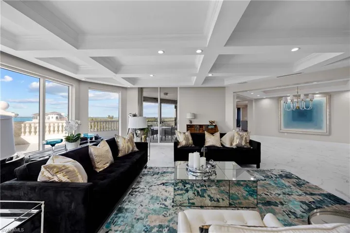 Living room featuring beam ceiling, ornamental molding, and coffered ceiling