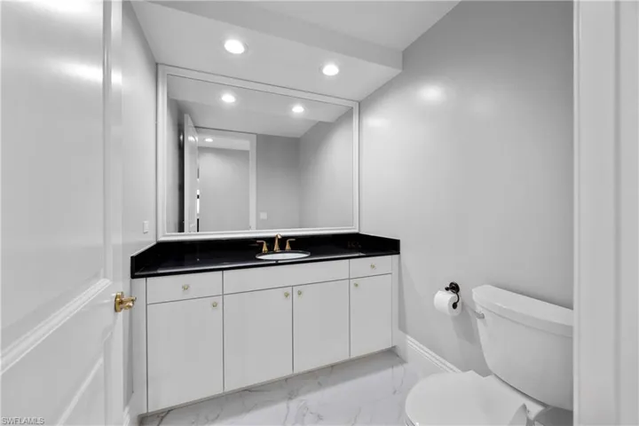 Powder room off the hallway across from kitchen