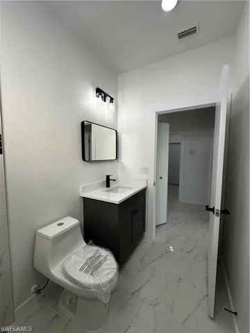 Bathroom featuring vanity and toilet
