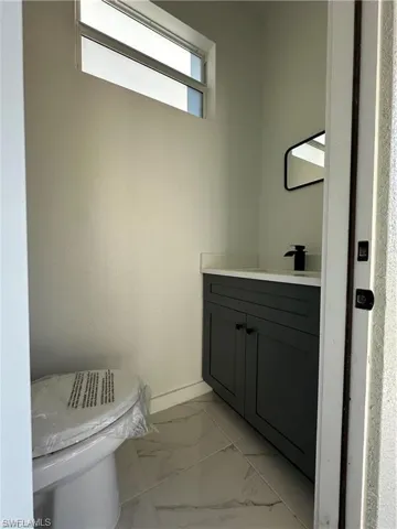Bathroom featuring vanity and toilet