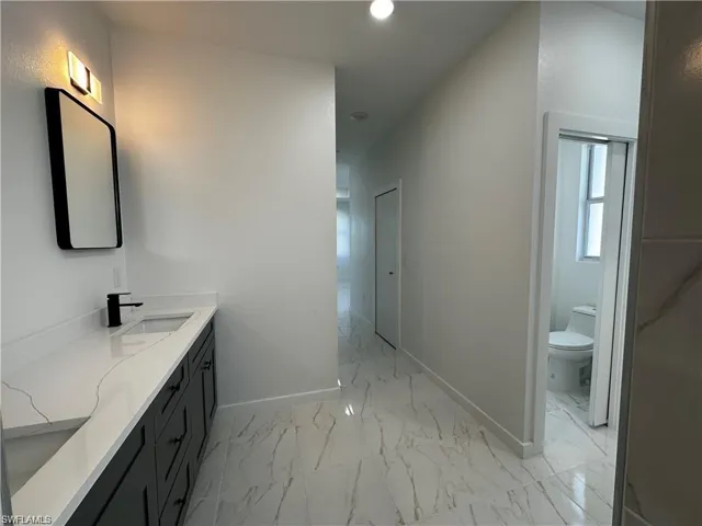 Bathroom with vanity and toilet