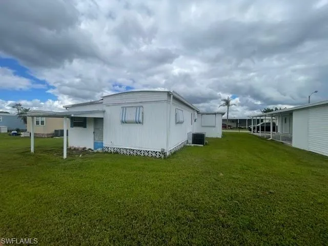 Rear view of house with a lawn