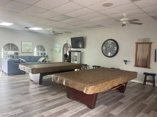Playroom with pool table, a ceiling fan, a drop ceiling, and a textured wall