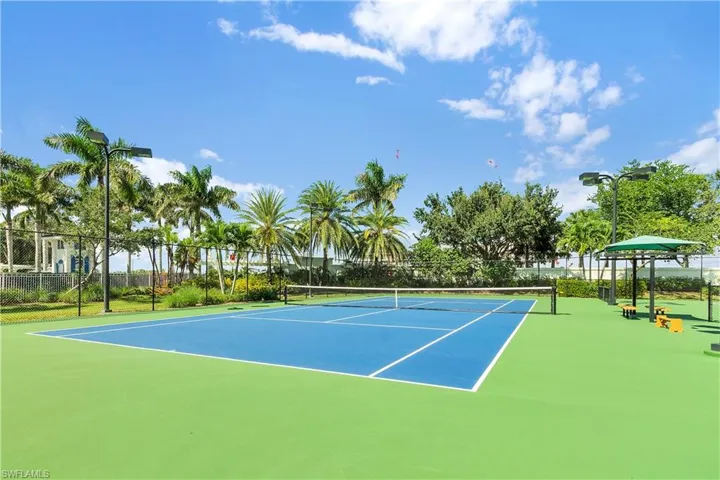 View of tennis court with community basketball court