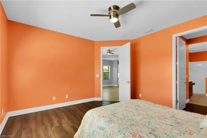 Bedroom featuring dark wood-type flooring and a ceiling fan