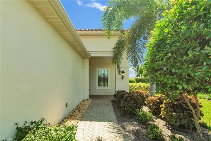 Entrance to property featuring stucco siding and a tiled roof