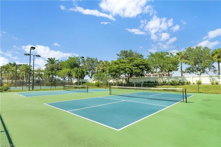 View of tennis court featuring community basketball court