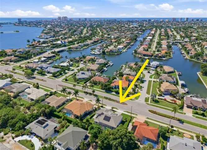 Aerial perspective featuring a residential canal-front community with proximity to the coastline